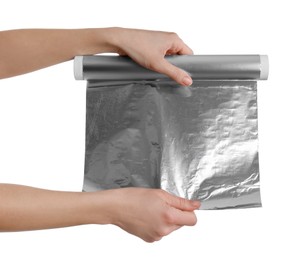 Woman holding roll of aluminum foil on white background, closeup