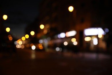 Photo of Blurred view of city street with lights at night. Bokeh effect