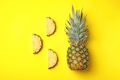 Photo of Flat lay composition with cut and fresh juicy pineapples on color background