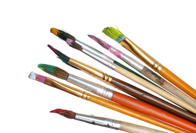 Photo of Different brushes with paints on white background