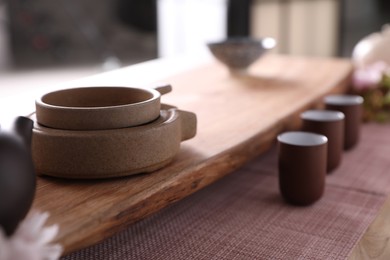 Photo of Tea filter and shelf, cup for traditional tea ceremony on table