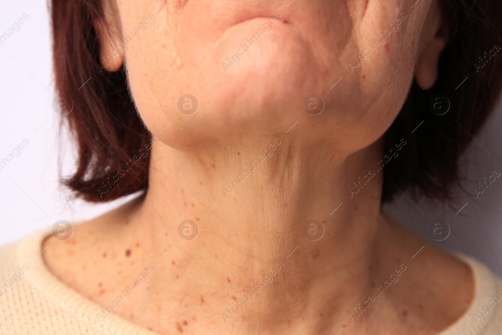 Photo of Closeup view of older woman on white background