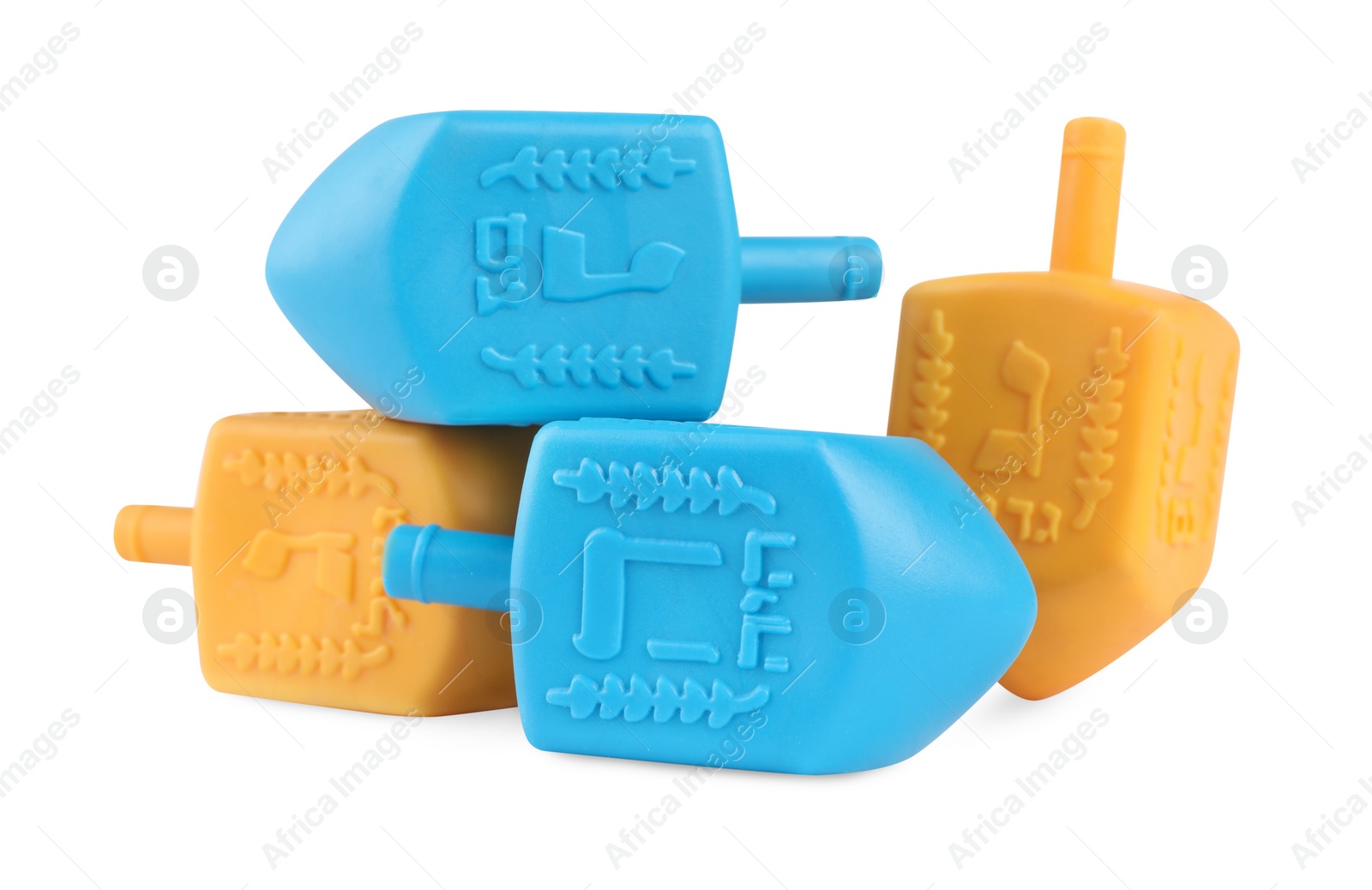 Photo of Hanukkah celebration. Colorful dreidels with jewish letters isolated on white