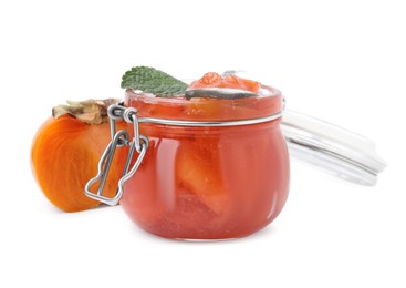 Photo of Jar of tasty persimmon jam with mint and fresh fruit on white background