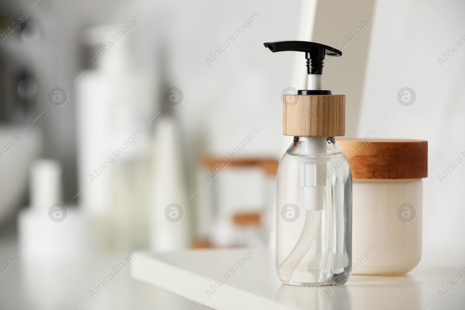 Photo of Different personal care products on shelf in bathroom, closeup. Space for text