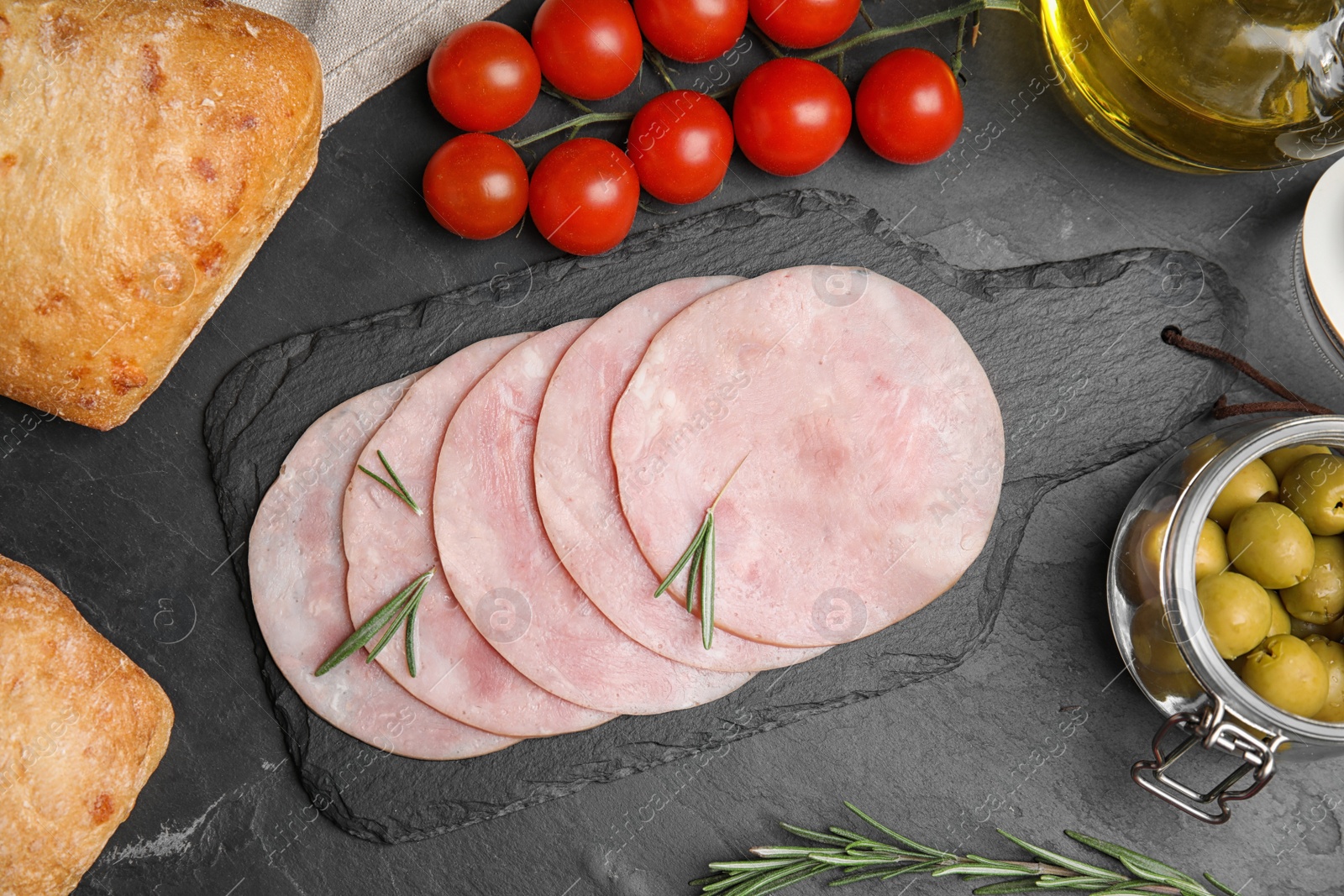 Photo of Tasty ham served on black table, flat lay