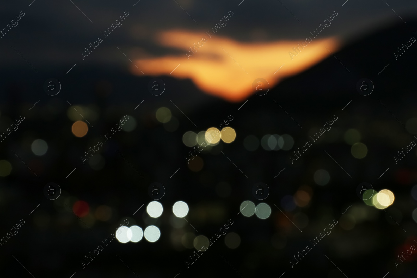 Photo of Blurred view of beautiful sunset with mountains in city, bokeh effect