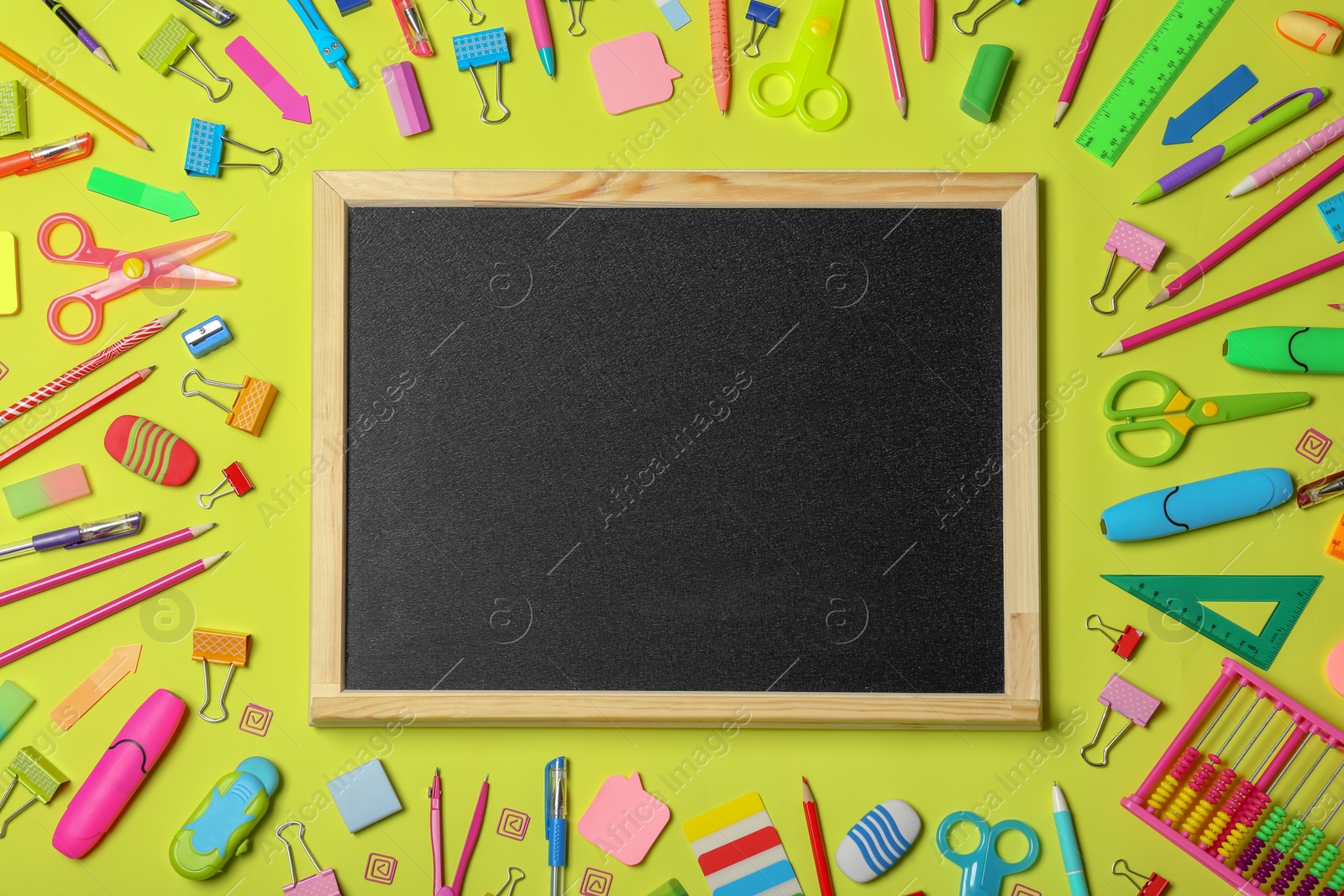 Photo of Flat lay composition with different school stationery and small chalkboard on color background