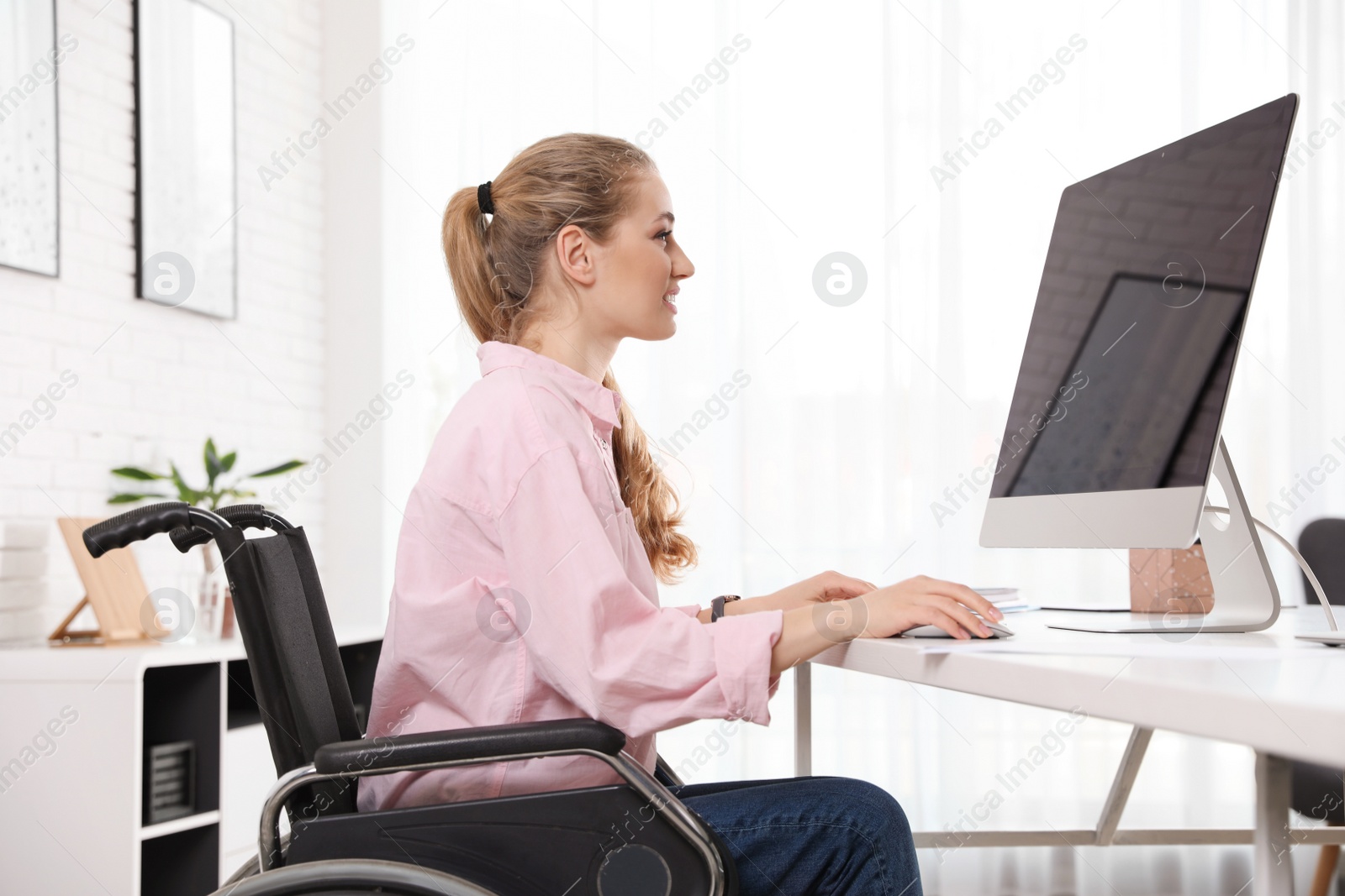 Photo of Portrait of woman in wheelchair at workplace