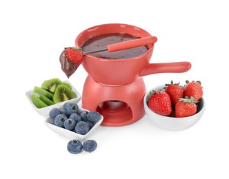 Photo of Fondue pot with melted chocolate, fresh berries, kiwi and fork isolated on white