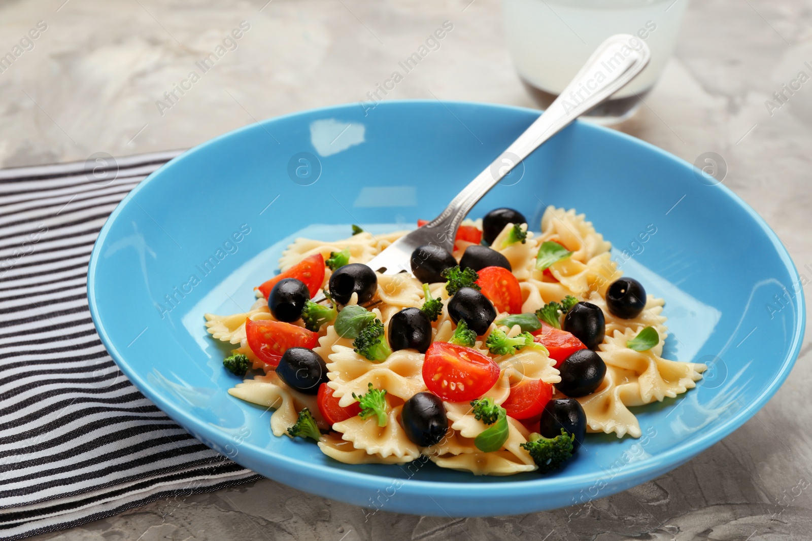 Photo of Tasty pasta salad with vegetables on table