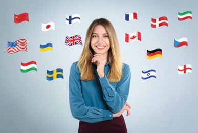 Portrait of interpreter and flags of different countries on light blue background