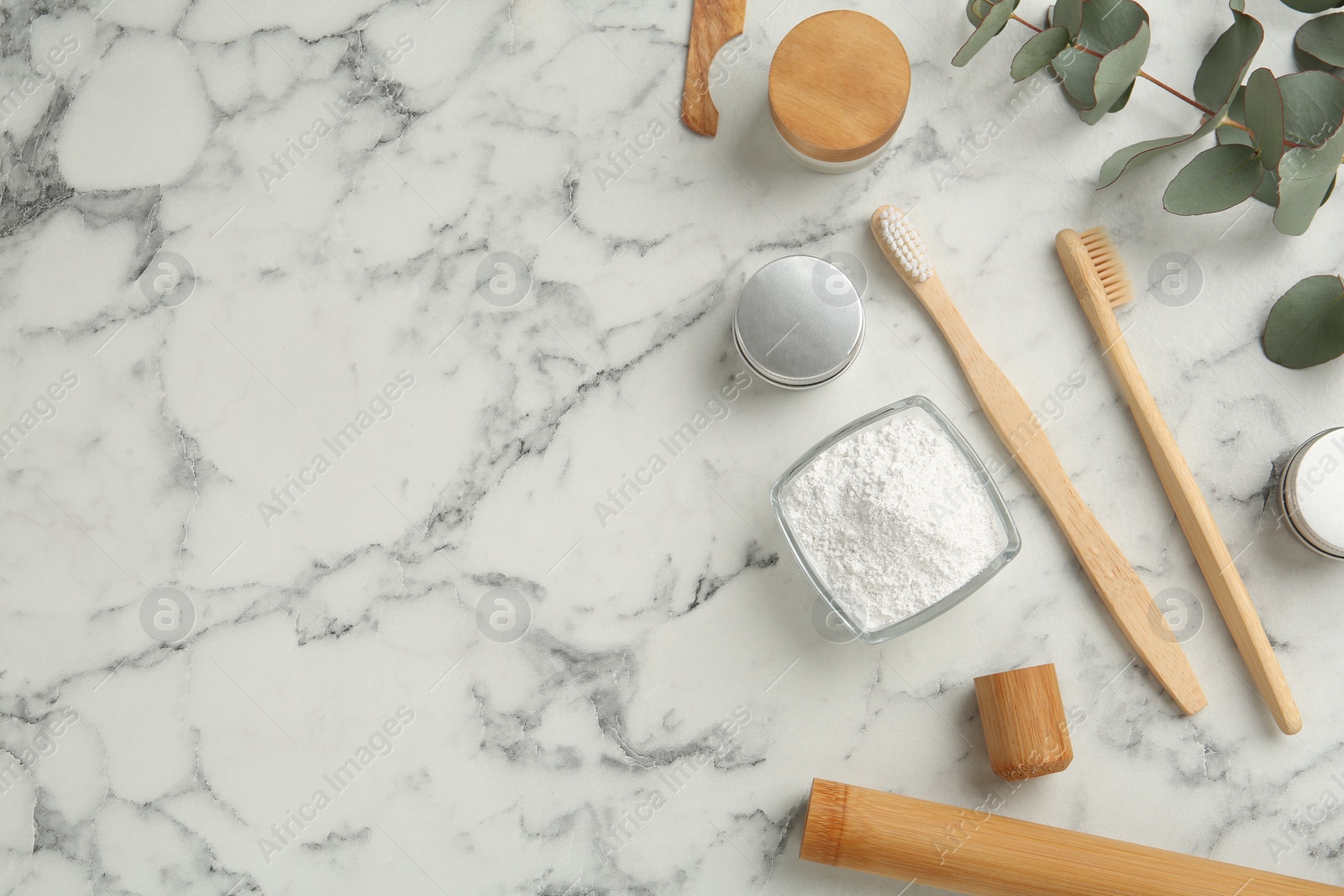 Photo of Flat lay composition with tooth powder and brushes on white marble table, space for text