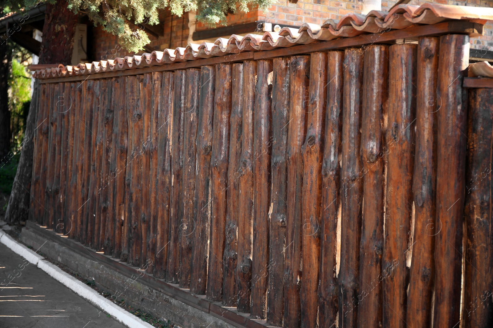 Photo of Brown wooden fence outdoors on sunny day