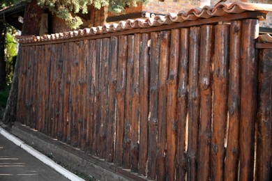 Photo of Brown wooden fence outdoors on sunny day