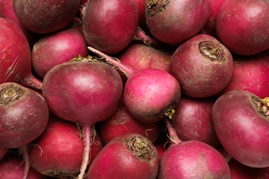 Photo of Pile of red turnips as background, top view