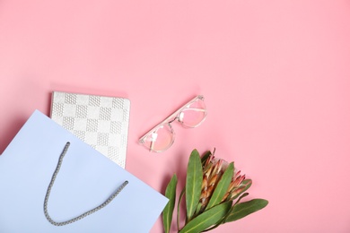 Photo of Stylish flat lay composition with shopping bag on color background