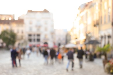 Photo of Blurred view of people walking on city street