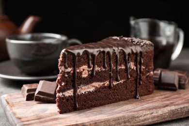 Photo of Delicious chocolate cake on grey table, closeup