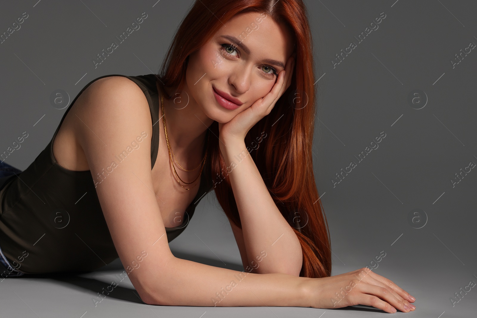Photo of Portrait of beautiful young woman on gray background