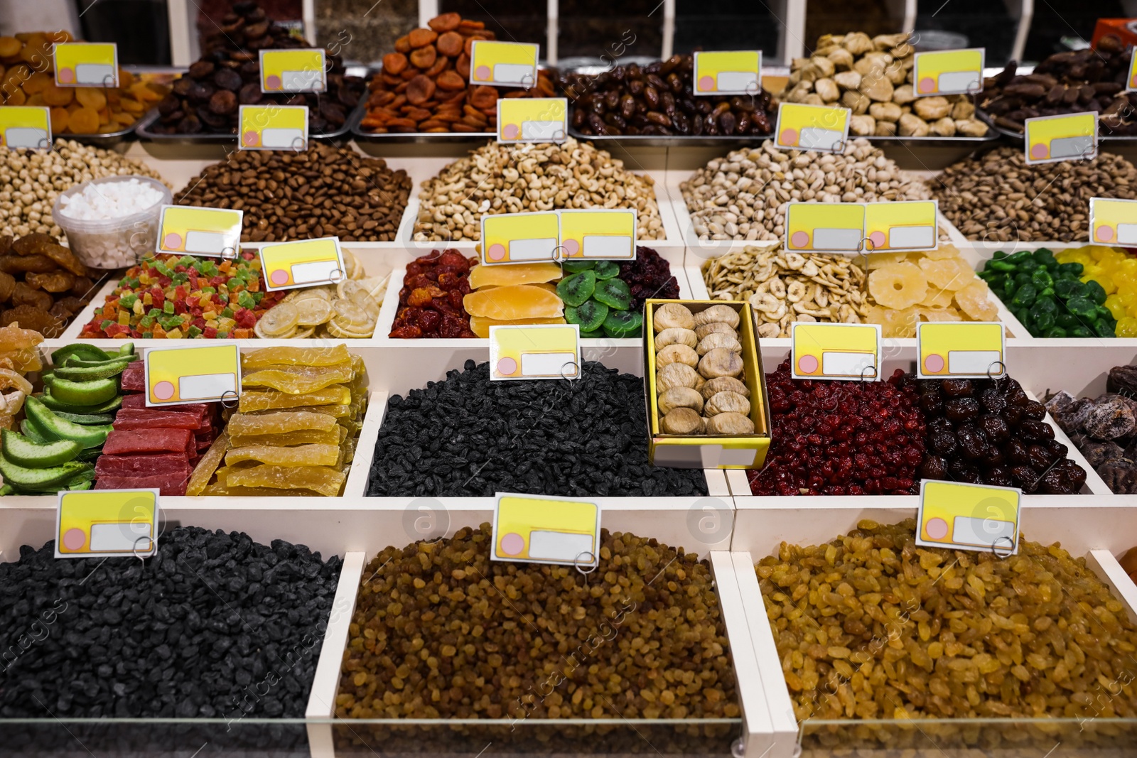 Photo of Assortment of delicious dried fruits and nuts at wholesale market