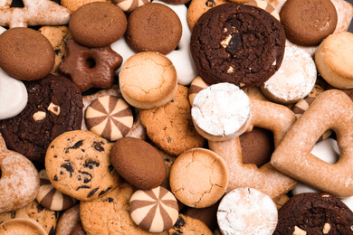 Photo of Different delicious cookies as background, top view