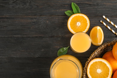 Composition with fresh orange juice on wooden background, flat lay. Space for text