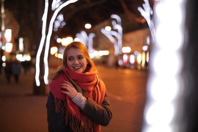 Photo of Beautiful young woman spending time in city at night