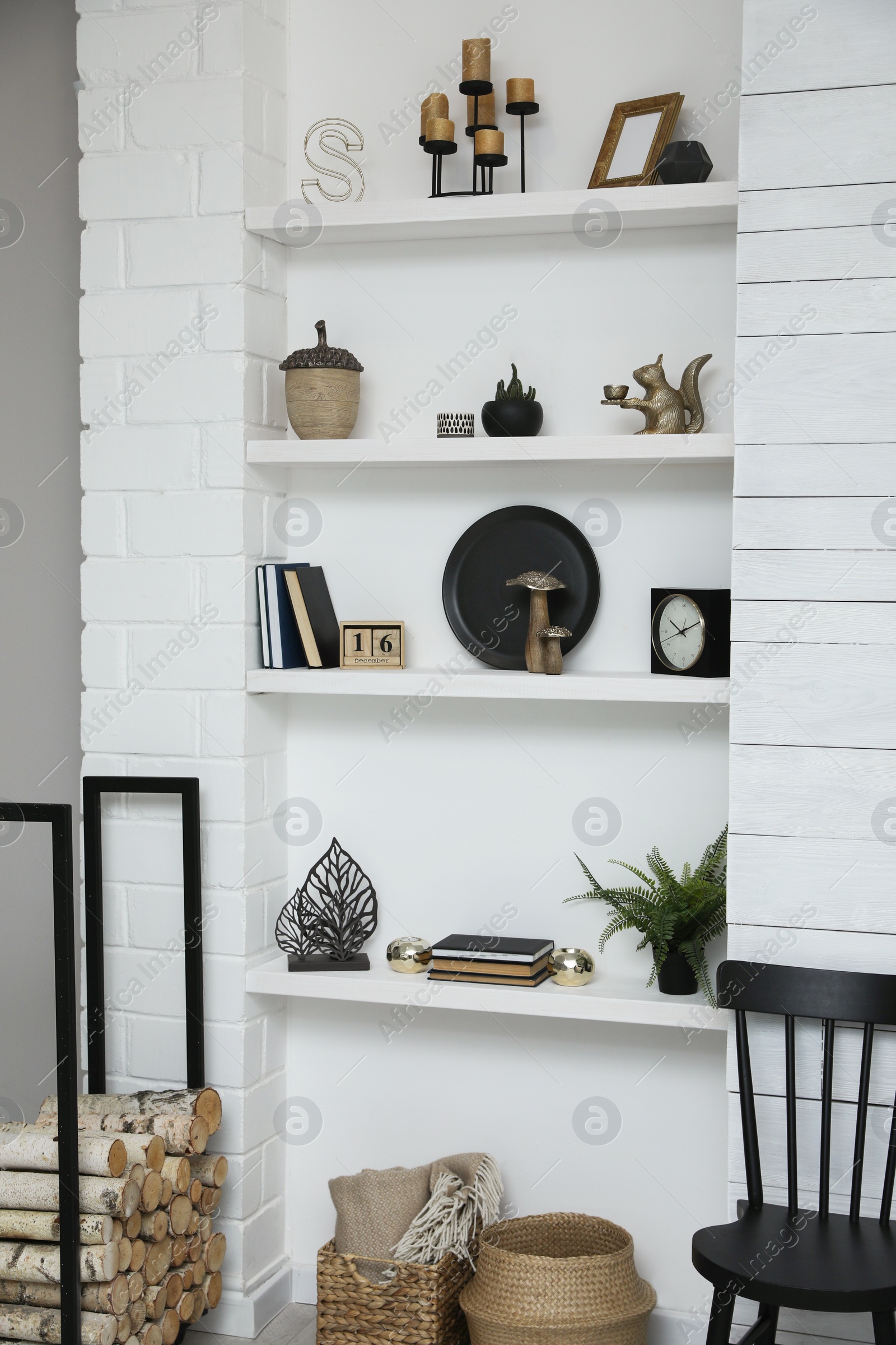 Photo of Many shelves with different decor in room. Interior design