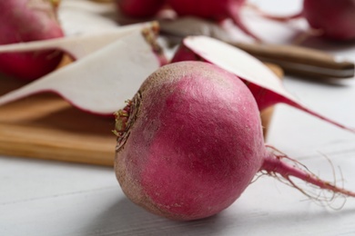 Photo of Ripe red turnip on white table, closeup