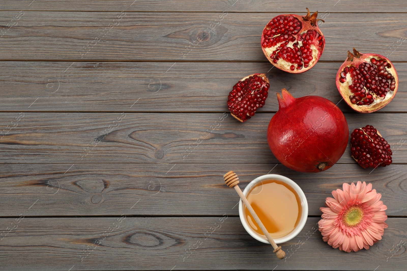 Photo of Flat lay composition with Rosh Hashanah holiday attributes on grey wooden table. Space for text