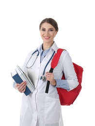 Young medical student with books and backpack on white background