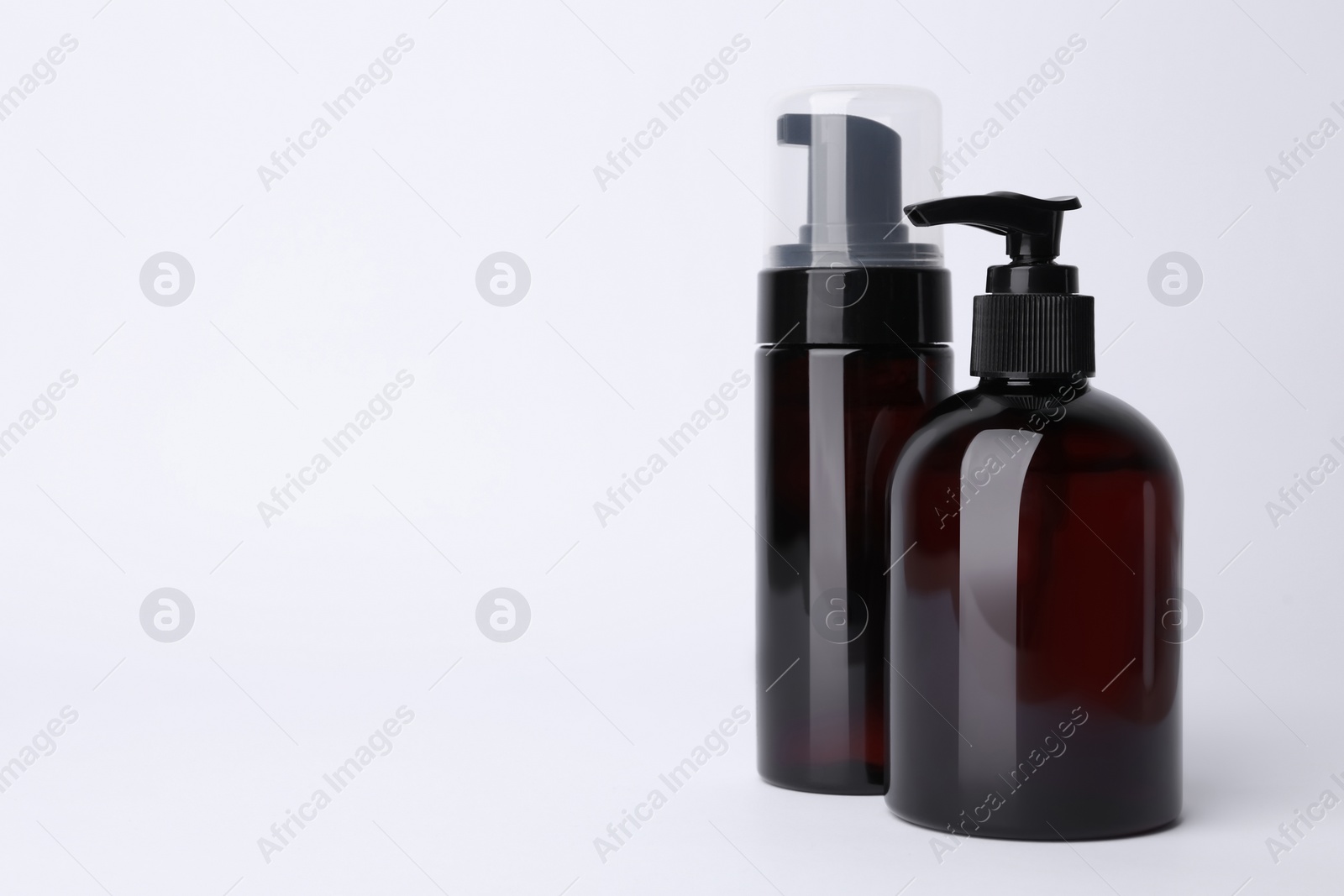 Photo of Different cleansers on white background, space for text. Cosmetic product