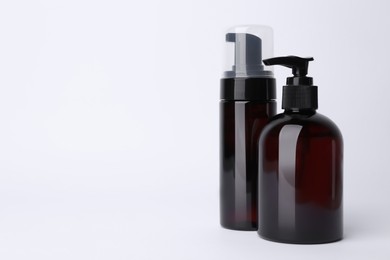 Photo of Different cleansers on white background, space for text. Cosmetic product