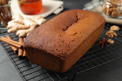 Delicious gingerbread cake and ingredients on cooling rack