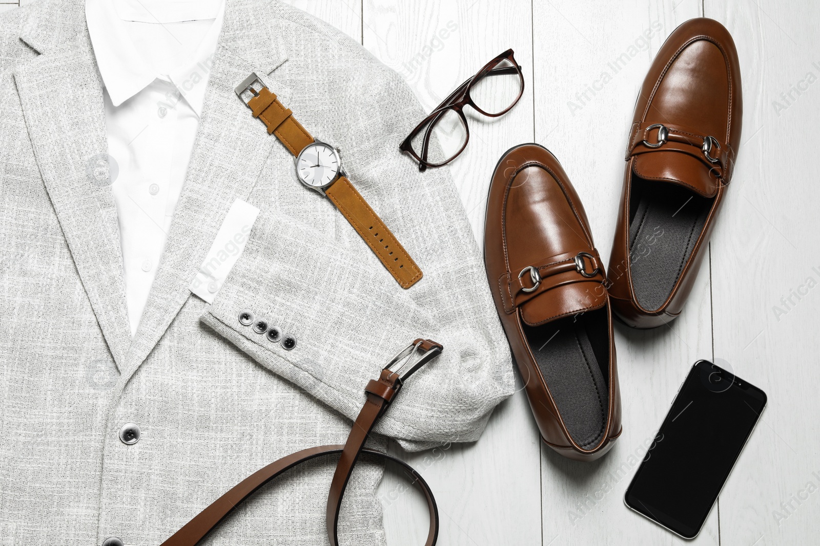 Photo of Flat lay composition with stylish clothes and accessories on white wooden background