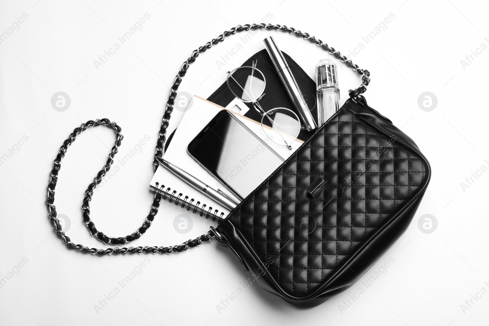 Photo of Stylish woman's bag with smartphone and accessories on white background, top view