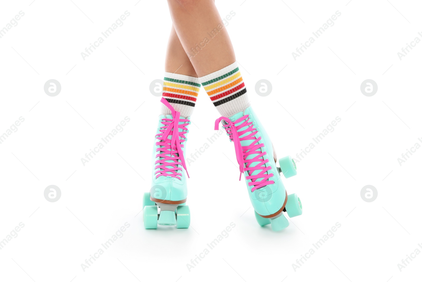 Photo of Young woman with vintage roller skates on white background, closeup view