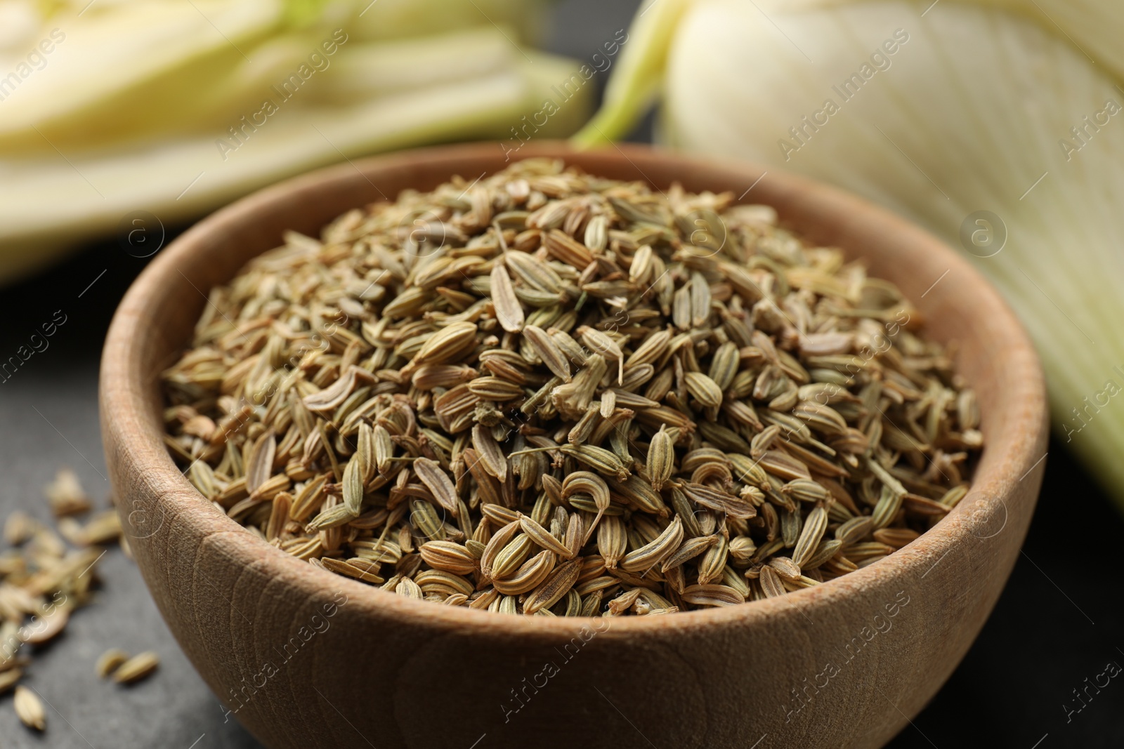 Photo of Fennel seeds in bowl on table, closeup