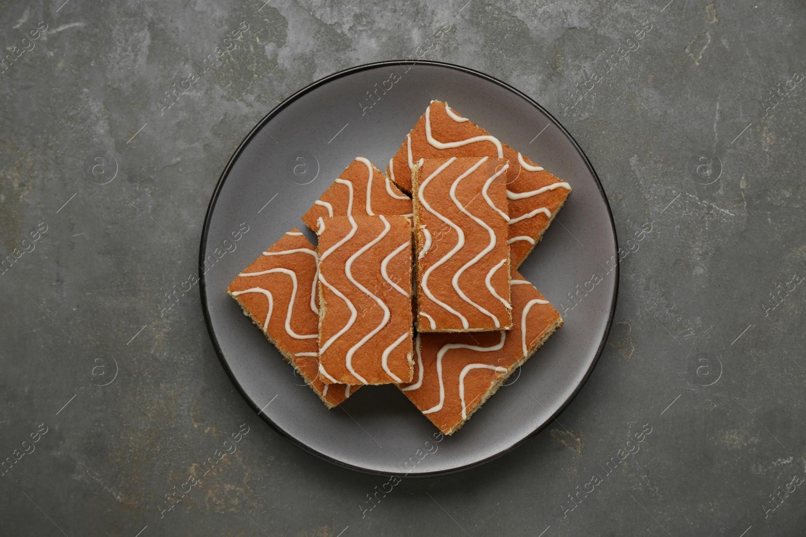 Photo of Tasty sponge cakes on grey table, top view