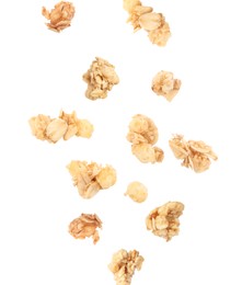 Image of Delicious granola falling on white background. Healthy snack  