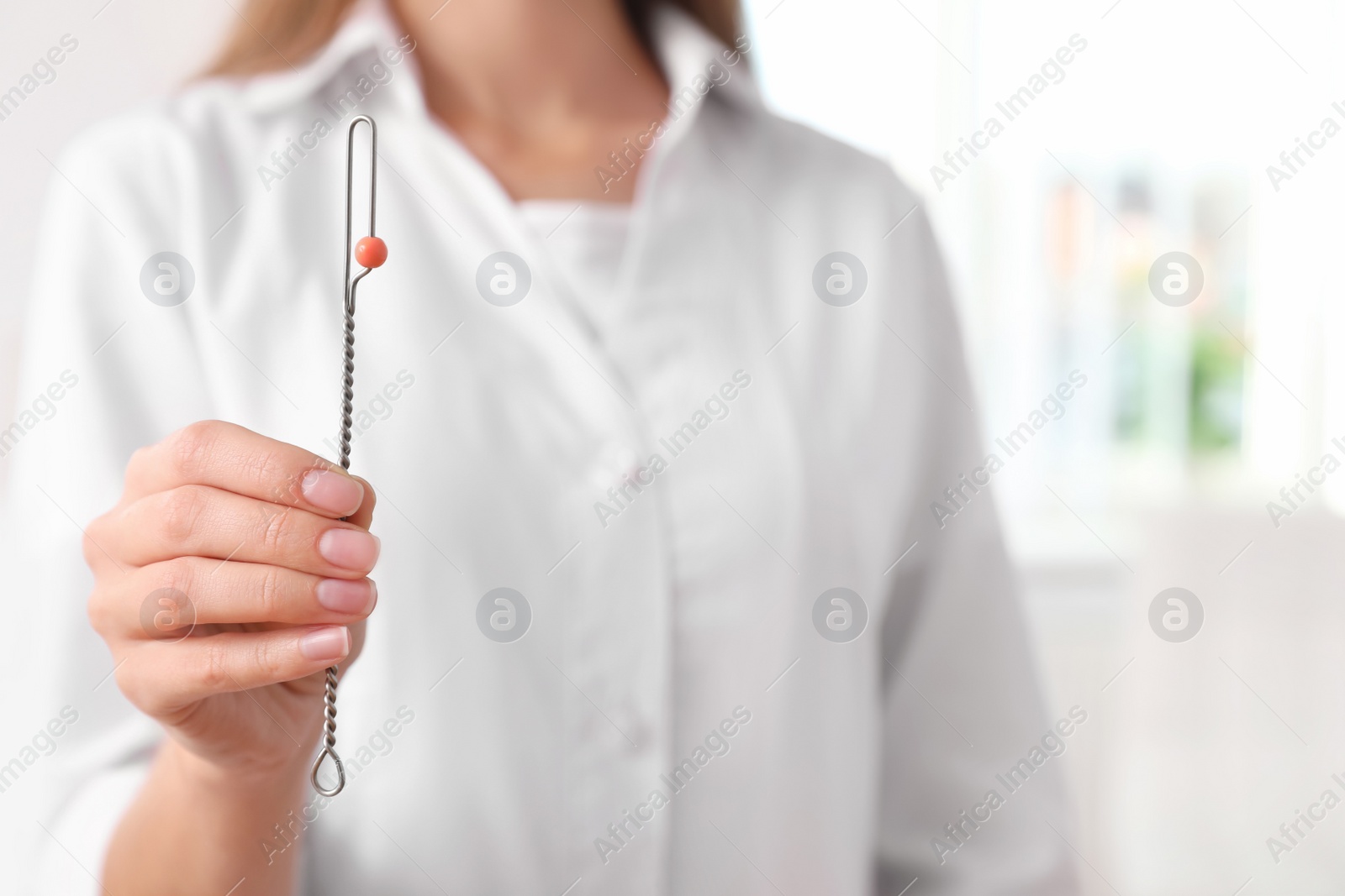 Photo of Speech therapist with logopedic probe in clinic, closeup. Space for text