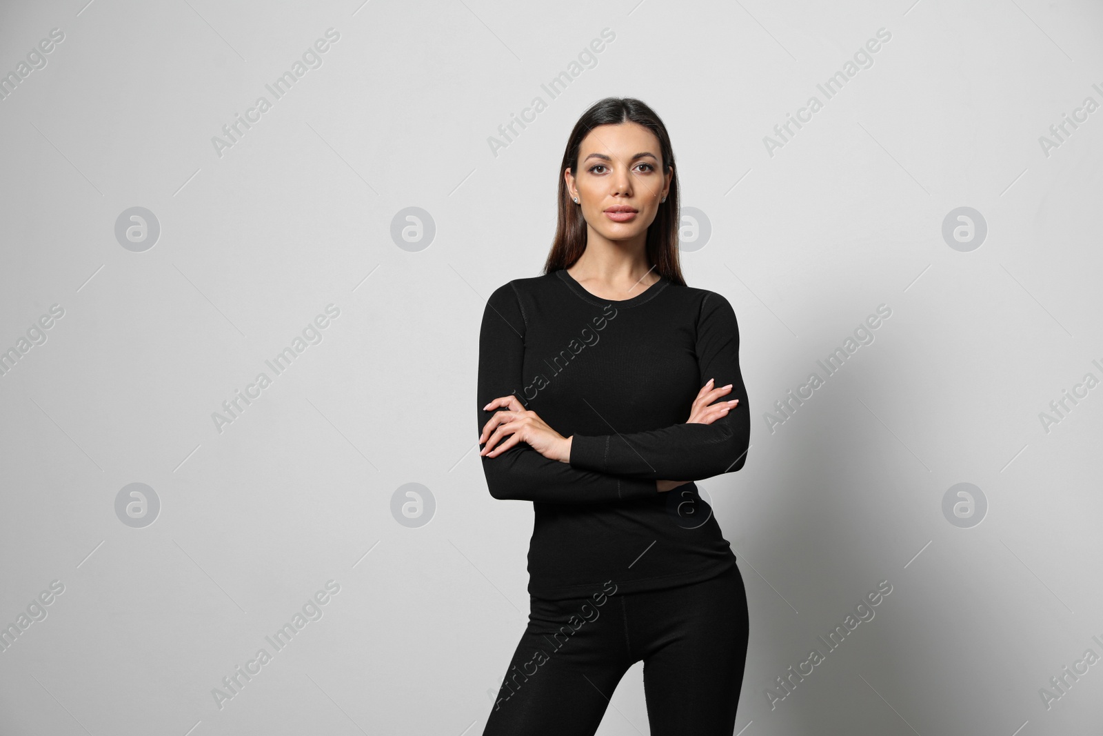 Photo of Woman wearing thermal underwear on light grey background. Space for text
