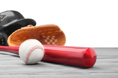 Photo of Baseball glove, bat, ball and batting helmet on grey wooden table against white background