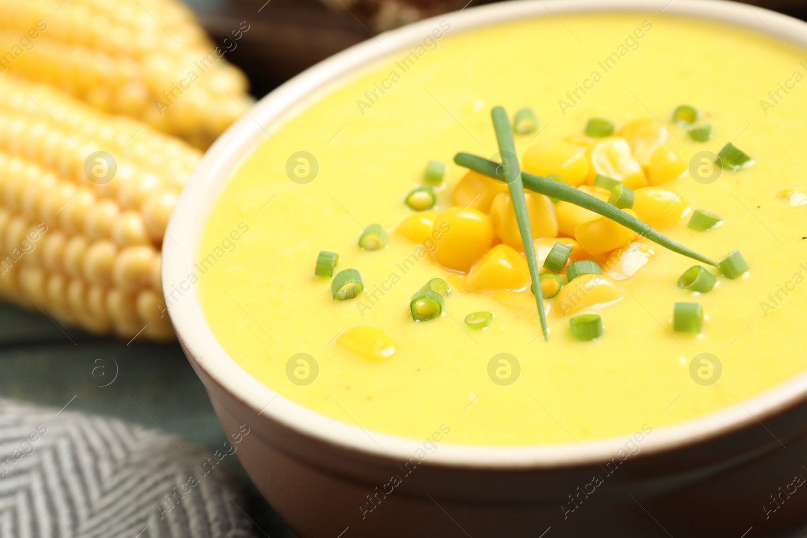 Photo of Delicious creamy corn soup on table, closeup