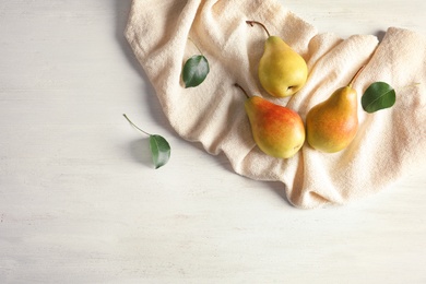 Photo of Flat lay composition with ripe pears on white wooden background. Space for text