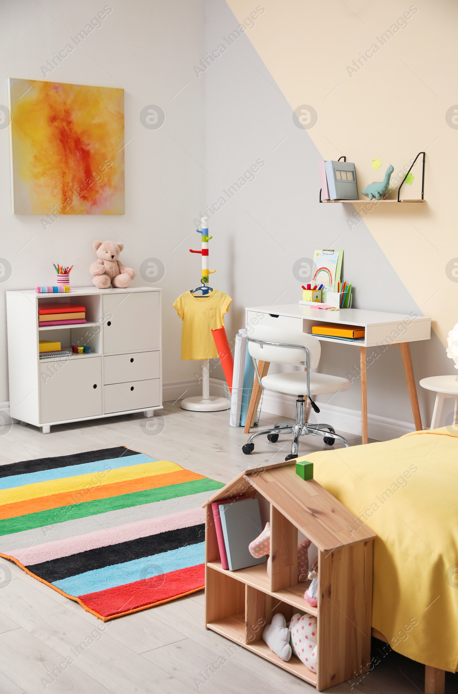 Photo of Stylish child room interior with comfortable bed and desk