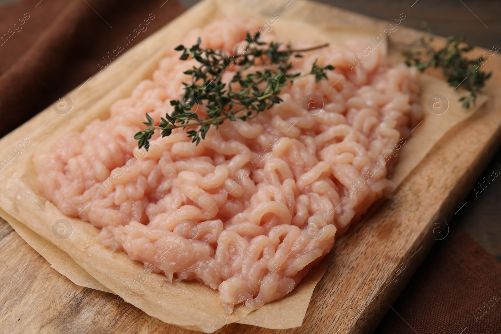 Photo of Fresh raw minced meat and thyme on table, closeup