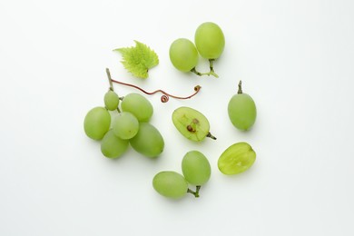 Photo of Fresh grapes and leaf on white background, top view