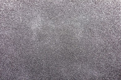 Photo of Beautiful shiny silver glitter as background, top view